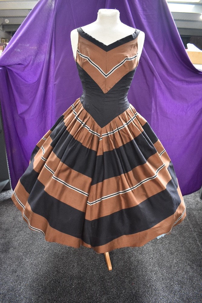 A 1950s American day dress,having fitted bodice drawing to a point in the centre, full pleated