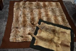 A late 19th/early 20th century hand made felt backed rabbit fur carriage rug and similar smaller