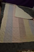 A late 19th/ early 20th century hand stitched quilt using bands of bright cotton fabrics.