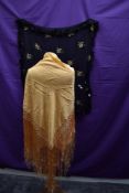 An early 20th century deeply fringed golden/apricot coloured shawl and another sheer fine black