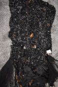 A distressed garment with a mass of black Victorian beads to be put to a new use, perfect for