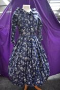 A 1950s polished cotton day dress with abstract rose pattern having full pleated skirt and shawl