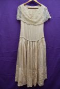 A cream silk and lace 1930s dress, having slight drop waist and press stud fastening to side.some