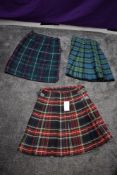 Three traditional kilts, one still having swing tag.