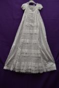 A late 19th/early 20th century christening gown having pin tuck and Broderie Anglais detailing.