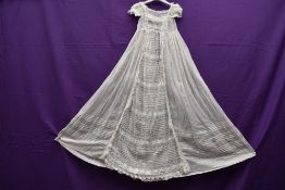 A Victorian lawn cotton christening gown having Pin tucks and lace work throughout.