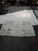 An early 20th century white bed throw and an embroidered table cloth.