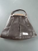 A 1930s leather handbag with butterscotch tone decoration to clasp handle with matching purse.