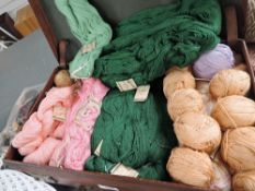 A suitcase full to the brim with fine knitting cotton in various cheerful shades.
