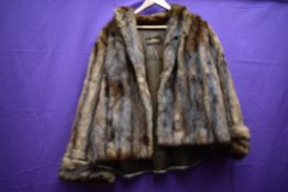 A short fur jacket,soft long pelt with longer guard hairs in a rich mahogany tone.