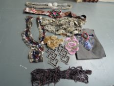 A selection of art deco sequinned panels, belts and lengths of beading and other decorations,