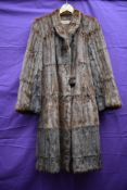 A Squirrel or similar fur coat,having Jean Dougal Macdonald,Sauchiehall St, Glasgow.