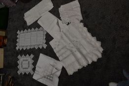 Five antique table cloths and two centre squares using a variety of intricate techniques including