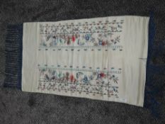 An early 20th century Chinese pocket sash having extensive colourful floral and butterfly embroidery