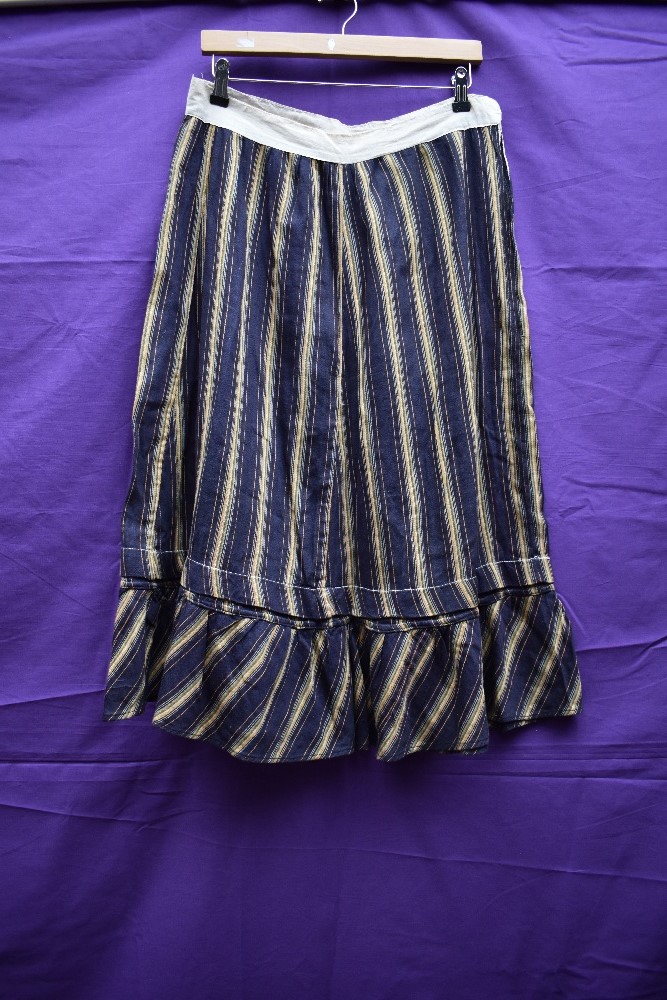 An early 20th century striped cotton skirt or petticoat, in navy, orange, blue and green, appears to