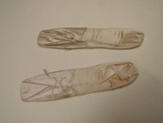 A pair of unworn 19th century ballet shoes, given by Helen May,soloist with Anna Pavlovas Ballet