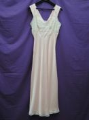 A 1950s full length baby pink nightdress having lace detailing to bust, Helen Stewart label, to fit