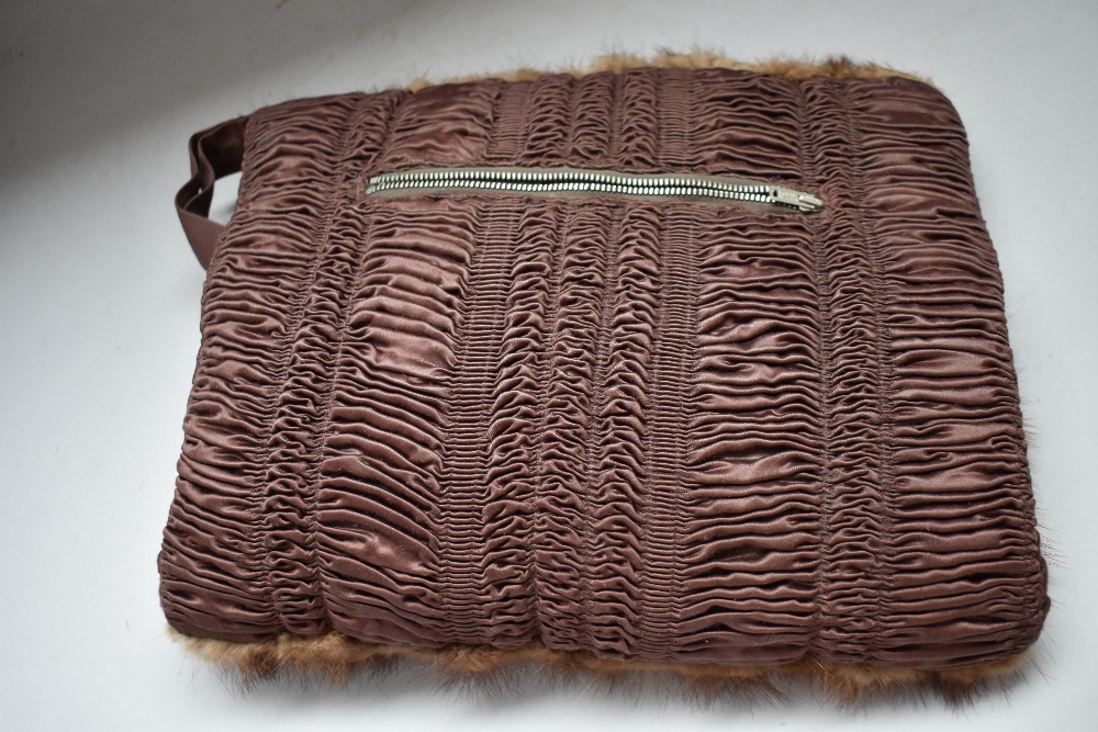 A mink fronted muff having heads attached with zip compartment to gathered reverse. - Image 2 of 2