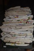 A Box of over fifty beautifully embroidered vintage and antique tables cloths.