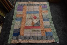 An early 20th century cot or childs bed quilt, pretty floral and check fabrics to front and backed