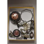 A selection of MG parts to include badges, number plate light fittings,switches and more.