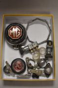 A selection of MG parts to include badges, number plate light fittings,switches and more.