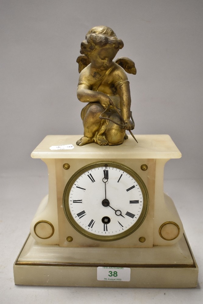 An early 20th century alabaster mantel clock having gilt cherub to top, enamel face and Roman