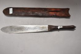 An early 20th century tribal or safari style machete knife with basic leather scabbard