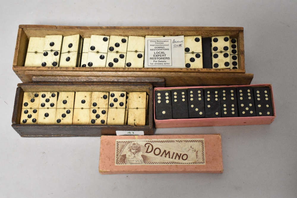 A selection of antique dominos in boxes.
