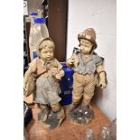 Two late Victorian terracotta figures of Dutch boy and girl fishing having had repairs 87cm tall