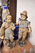 Two late Victorian terracotta figures of Dutch boy and girl fishing having had repairs 87cm tall
