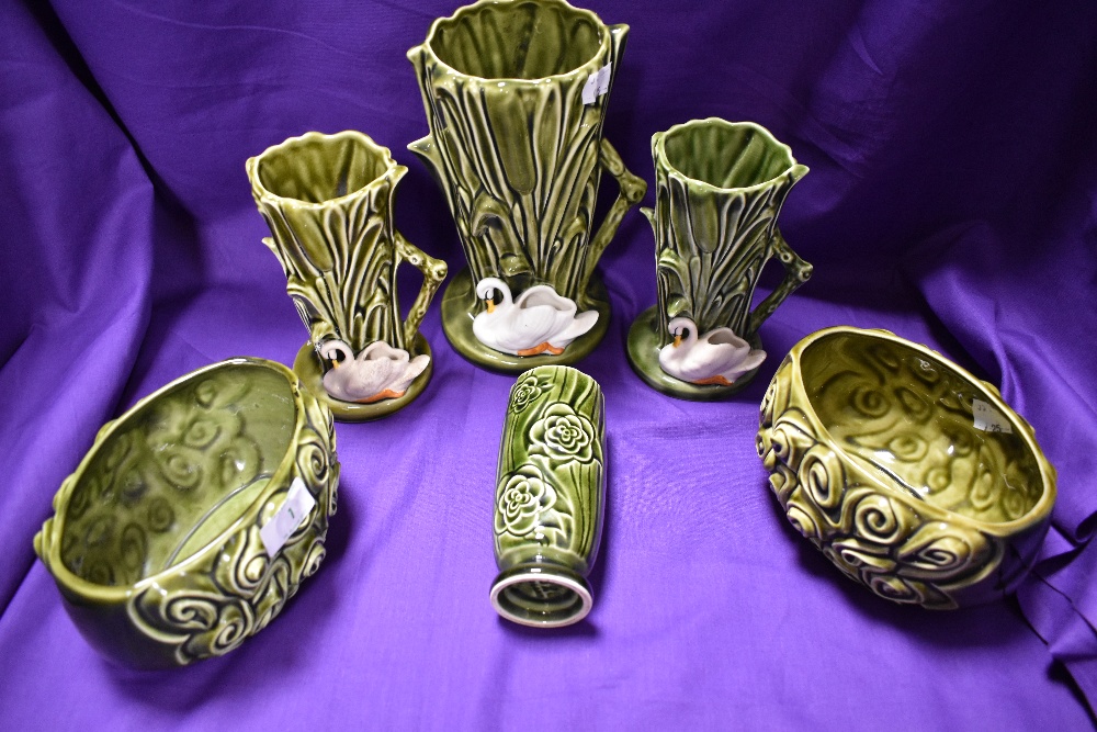 A collection of mid century Sylvac vases and planters, having swans to some...