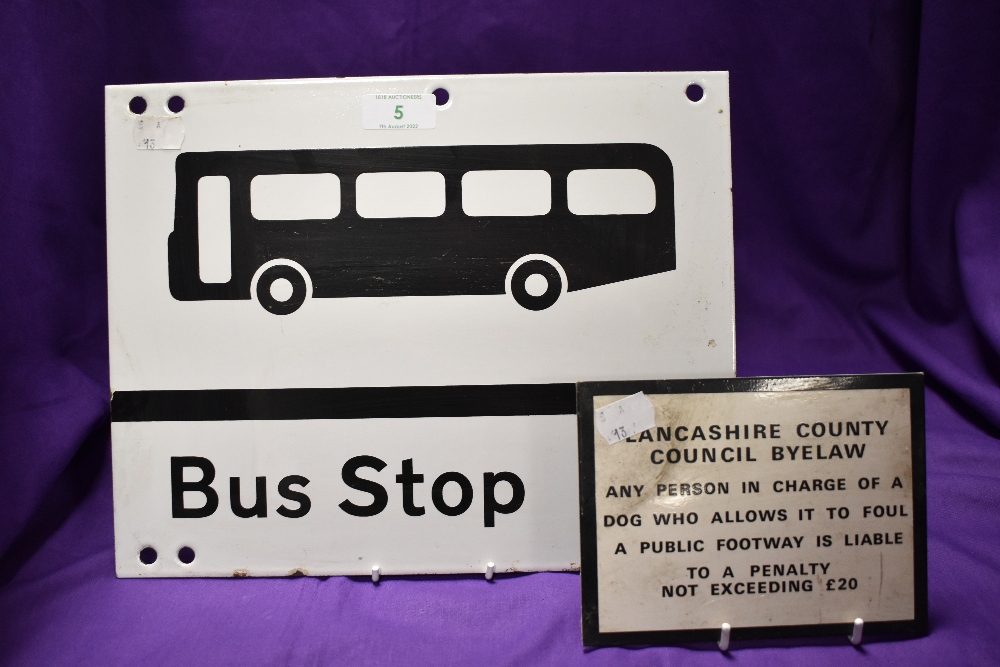A double sided enamel bus stop sign and a smaller metal plaque for...