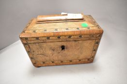 A 19th century walnut veneered tea caddy having parquetry inlaid edging to lid and front and two