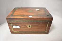 An early 20th century box having brass inlay to top and front, brass escutcheon, no key, some losses