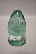 A Victorian green glass dump weight with floral sulphide decoration