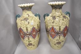 A pair of large Oriental style two handled vases having tube lined style decoration, height approx