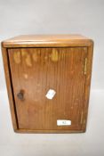 A mid century oak smokers cabinet having internal drawer and pipe rack.