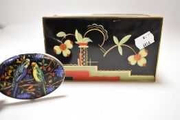 An Art Deco styled cigarette box having floral and geometric pattern painted to lid in red and green