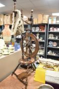 Victorian spinning wheel having turned oak and mahogany frame