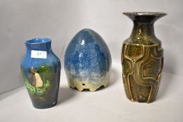 Two studio pottery vases, one teal blue with bird design,the other with embossed geometric pattern