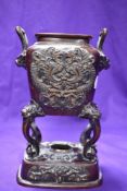 A 20th century Japanese bronze censer sat atop four legs having Dragons to tops of each.