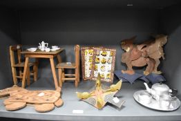 A collection of early 20th century children's wooden toys including dolls table and chairs, dog