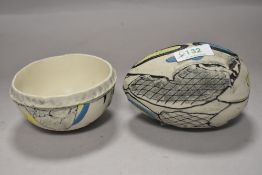 Two items of textured studio pottery in blue and yellow tones on natural ground, both marked KB to