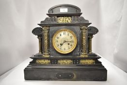 A late 19th/early 20th century black slate mantel clock having French movement, gilt scenes