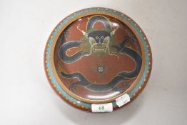 A Chinese cloisonné bowl having dragons to sides and interior.