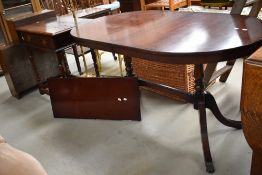 A 20th century reproduction Regency style mahogany extending dining table