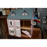 A mid to late 20th century childrens toy doll house with accessories furniture and dolls