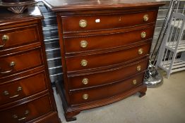 A reproduction bow fronted chest of five long drawers, in the Regency style, width approx. 80cm