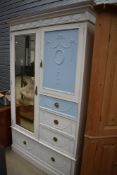 A 20th century painted pine shabby chic style wardrobe and drawer unit in a French style